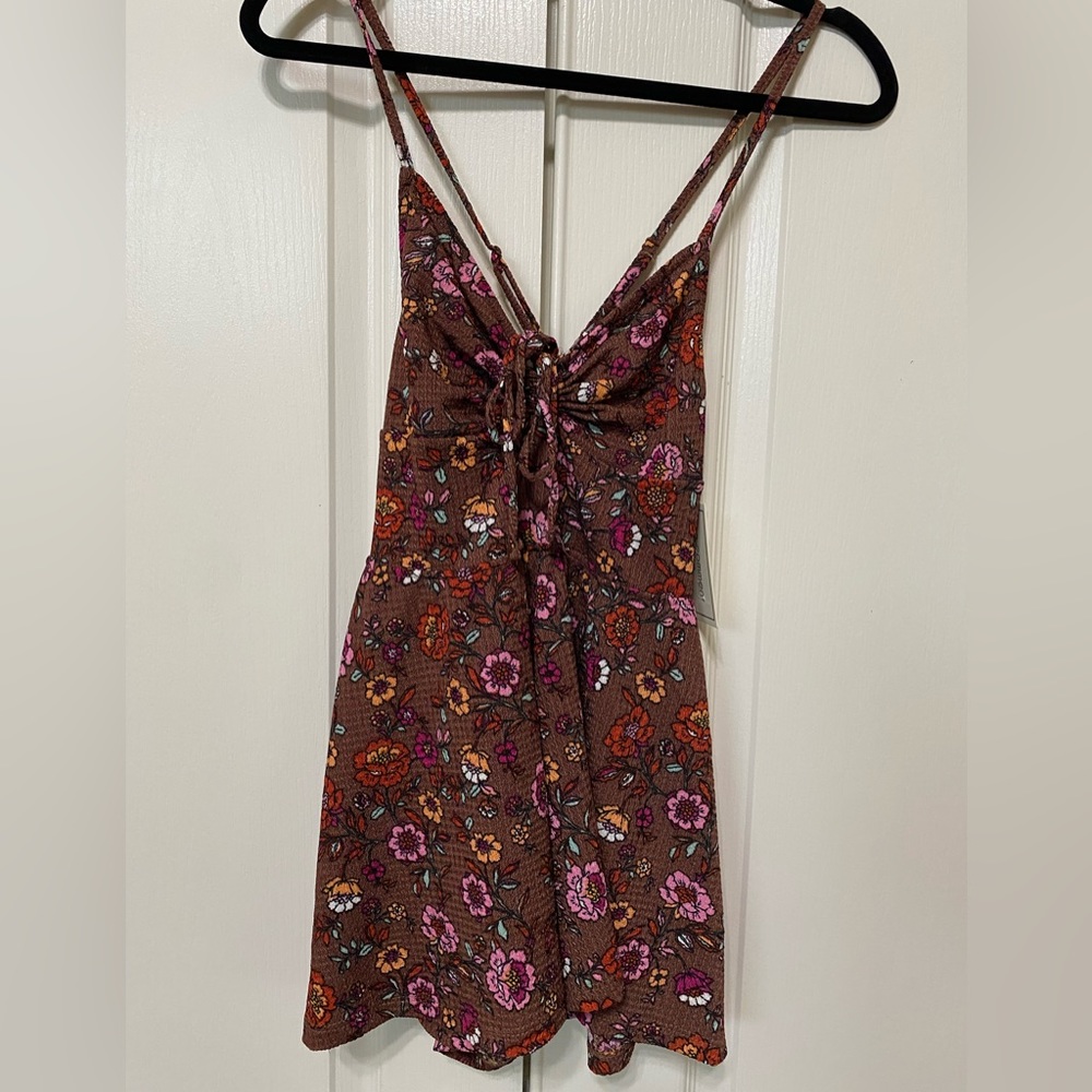 New with tags romper size small. Brown with flowers
